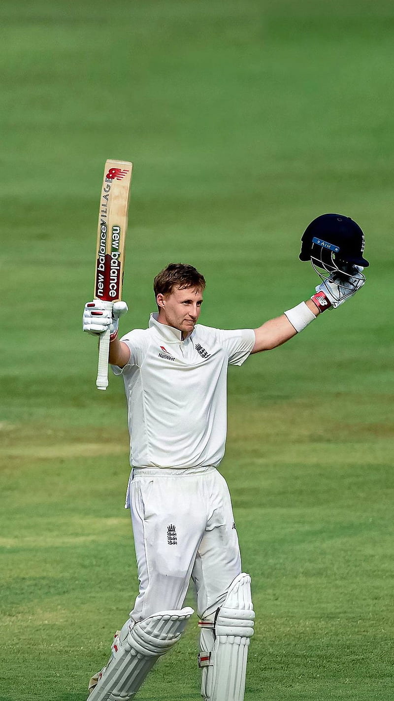 JOE ROOT holding a bat and helmet