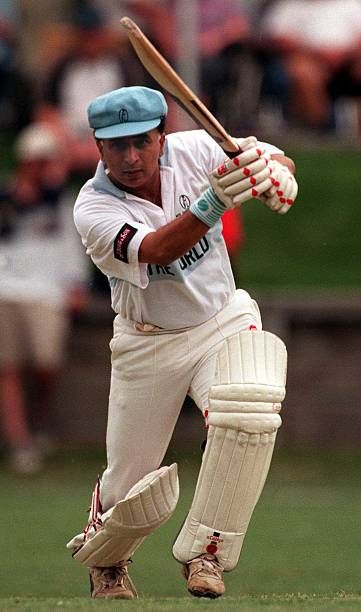 SUNIL GAVASKAR in a white uniform swinging a bat