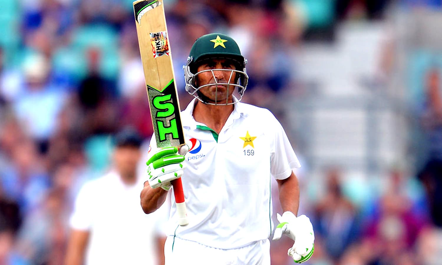 A man (YOUNIS KHAN) holding a bat